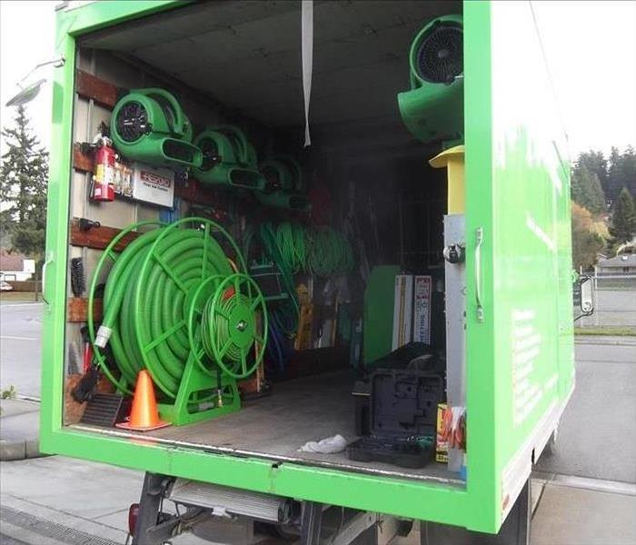 inside of a SERVPRO truck showing green equipment