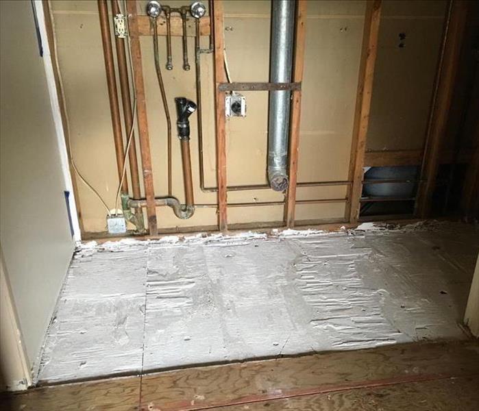 water damaged floor in  laundry room