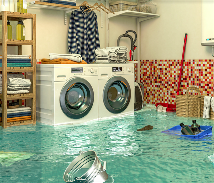 a flooded laundry room with water covering the floor and furniture floating everywhere