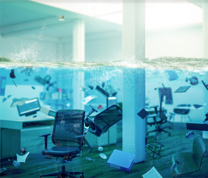 a flooded office with chairs floating around