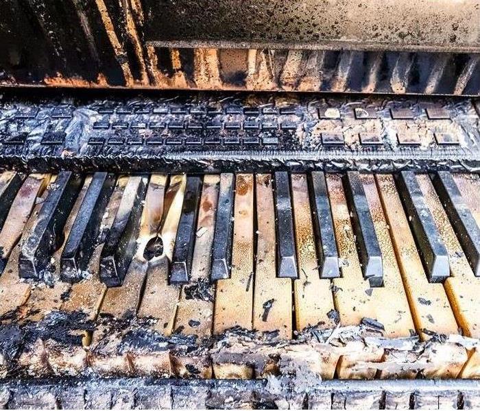 close up o fire damaged piano keyboard
